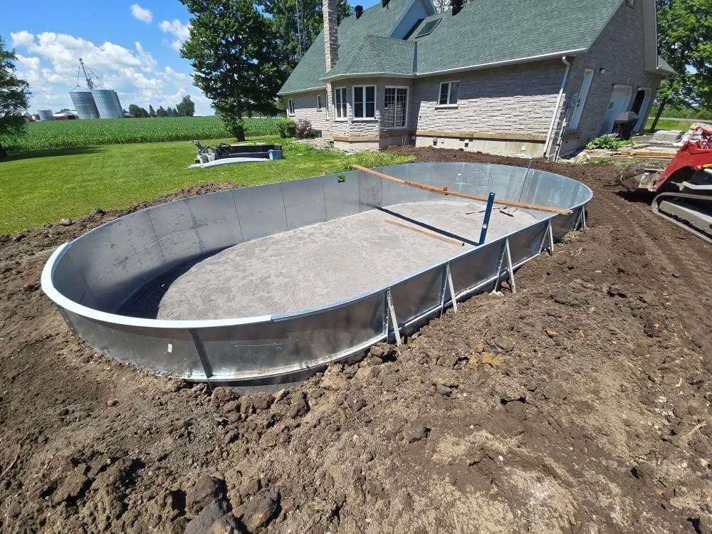 Above-ground pool wall with screeded stone dust base at a farm property